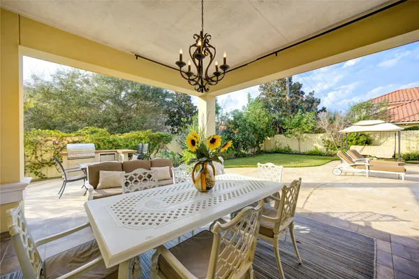 a view of an outdoor dining space with furniture and garden view