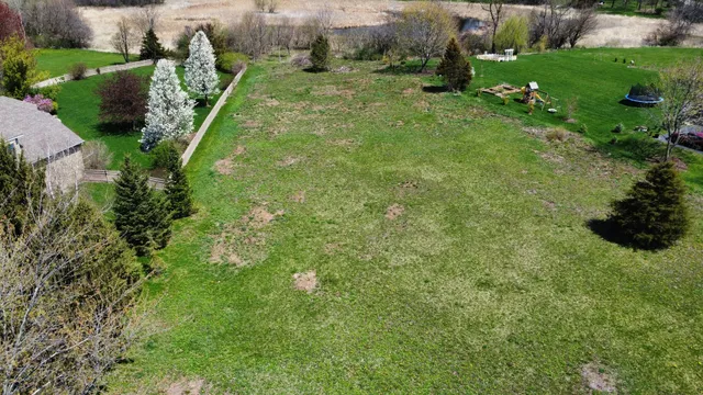 an aerial view of a house with a yard