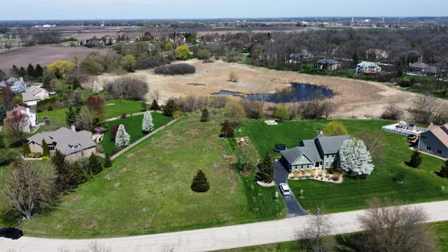 an aerial view of a house with yard