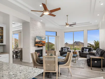 a very nice looking dining room with a large window and stainless steel appliances