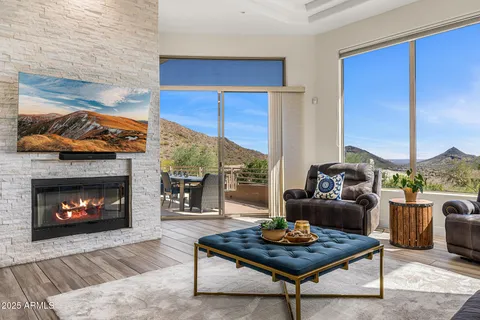 a living room with furniture a fireplace and a table