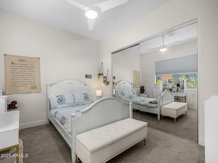 a bedroom with a bed and a lamp on table