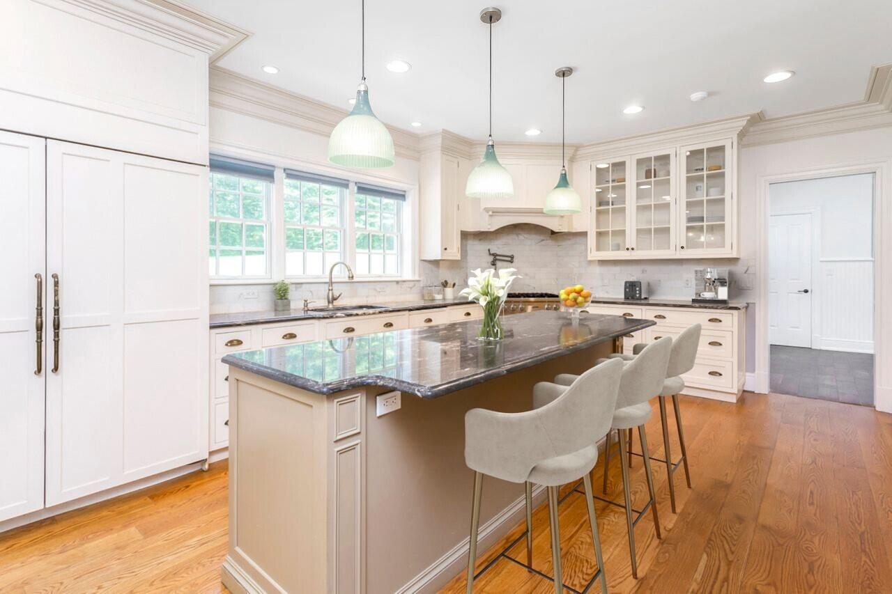 274 Mariomi Road New Canaan, CT 06840 - Photo 13 of 56 a kitchen with granite countertop a stove a sink a dining table and chairs