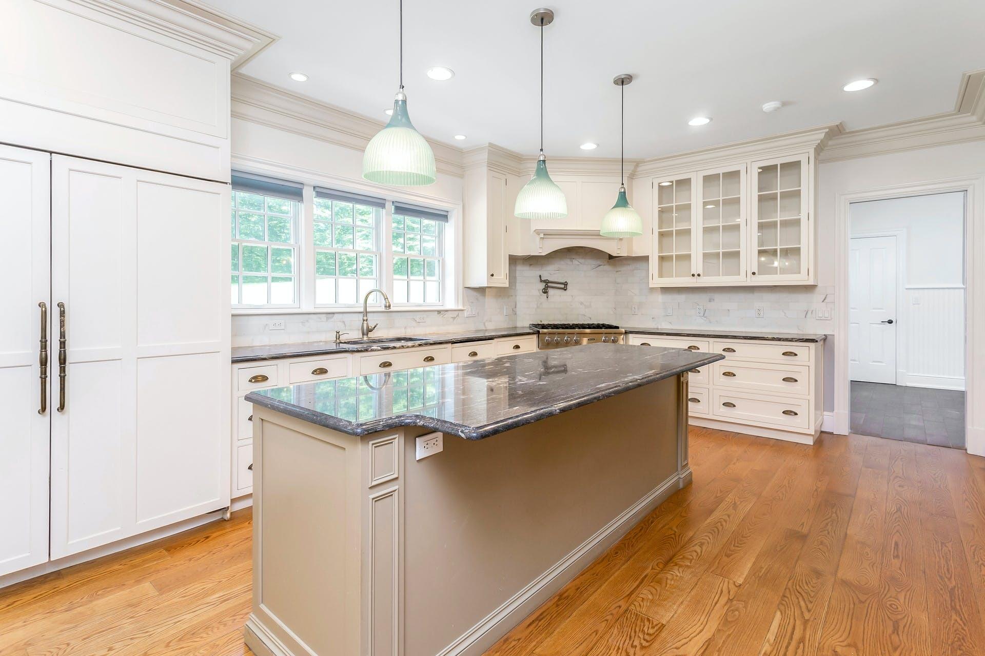 274 Mariomi Road New Canaan, CT 06840 - Photo 14 of 56 a kitchen with stainless steel appliances granite countertop a sink a stove a refrigerator and island with wooden floor