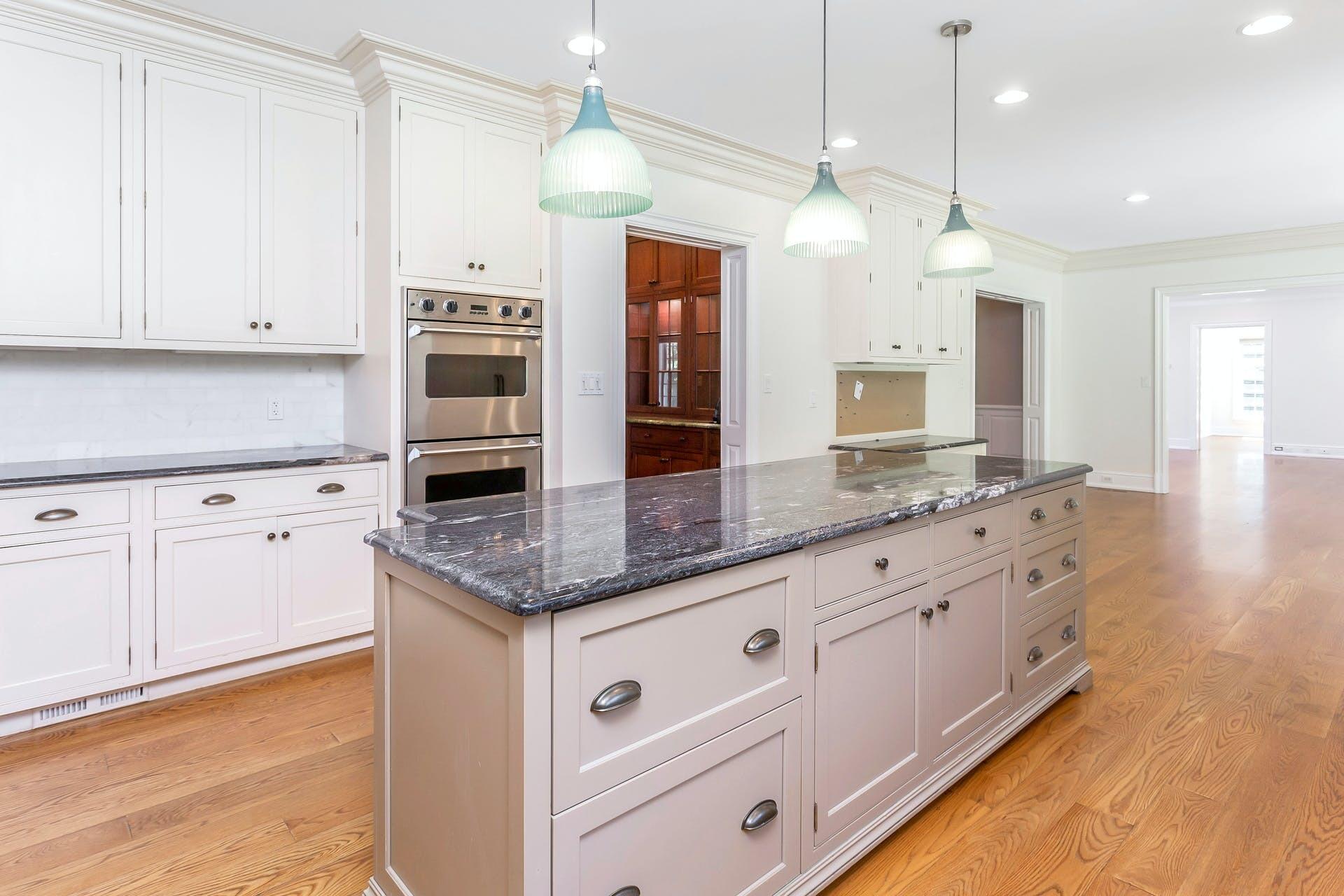 274 Mariomi Road New Canaan, CT 06840 - Photo 16 of 56 a kitchen with granite countertop white cabinets and stainless steel appliances