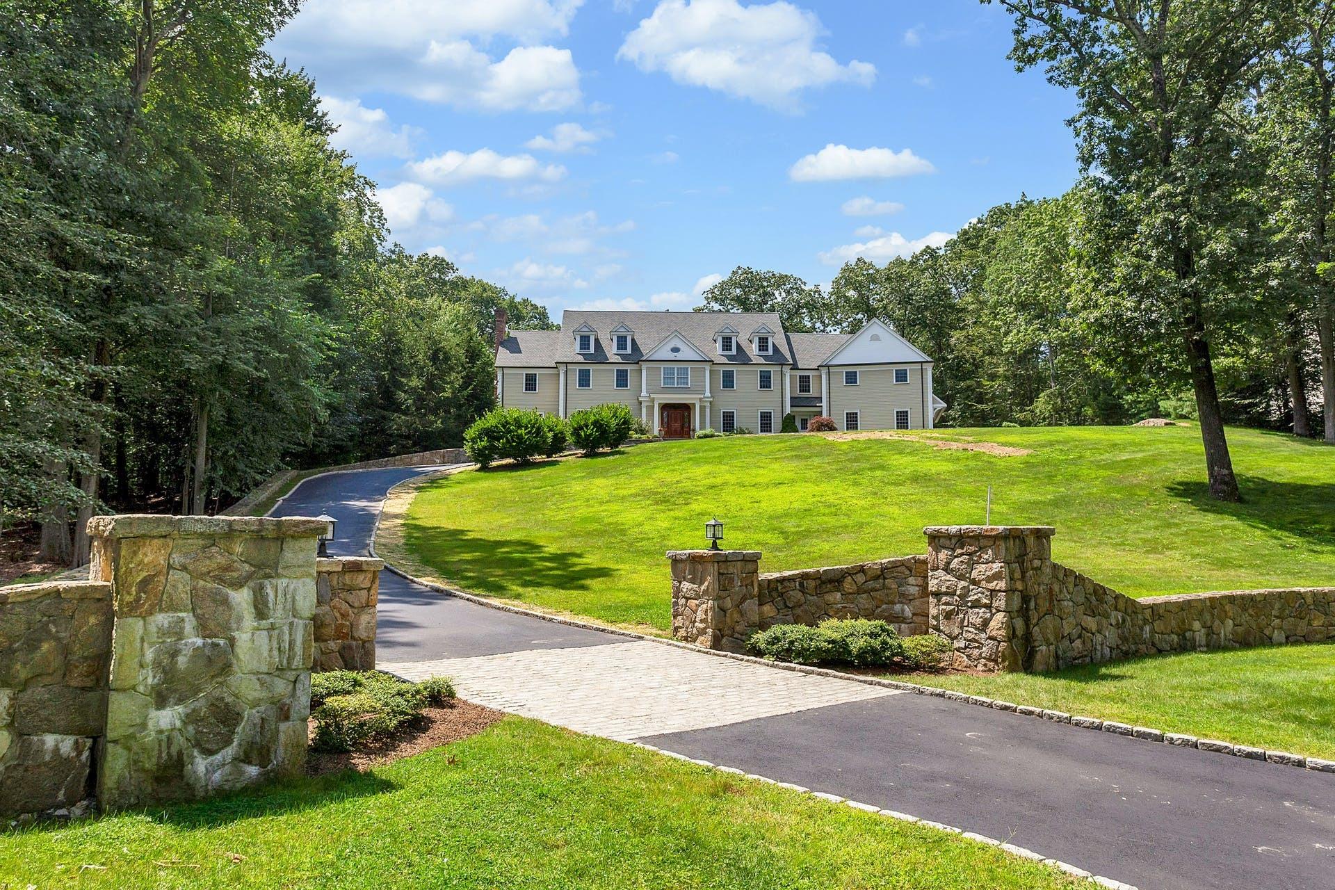274 Mariomi Road New Canaan, CT 06840 - Photo 2 of 56 a view of a house with a yard
