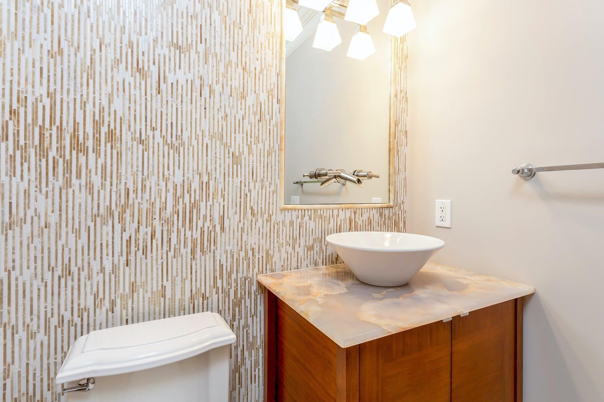 274 Mariomi Road New Canaan, CT 06840 - Photo 22 of 56 a bathroom with a toilet a sink and a mirror