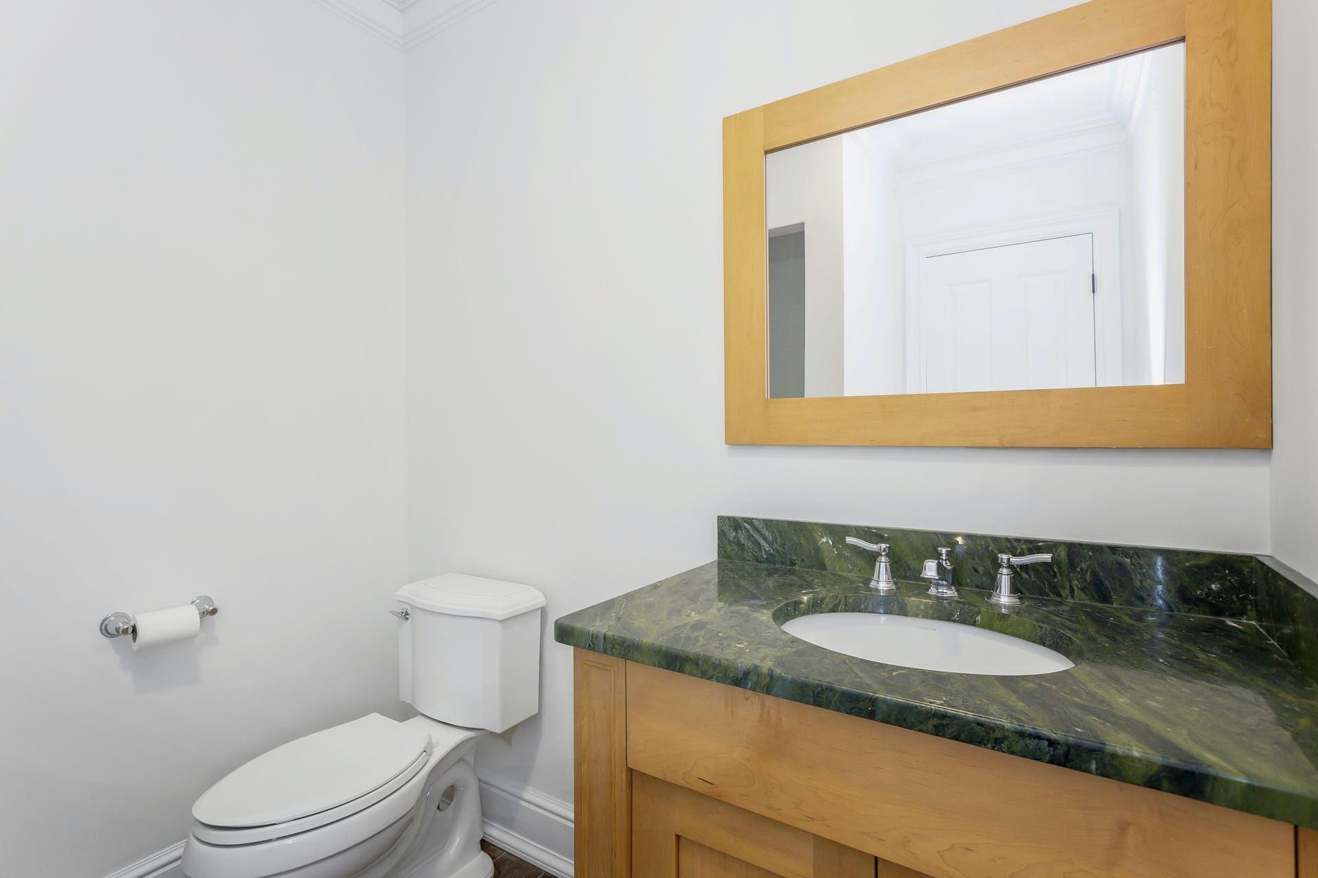 274 Mariomi Road New Canaan, CT 06840 - Photo 24 of 56 a bathroom with a granite countertop sink and a mirror