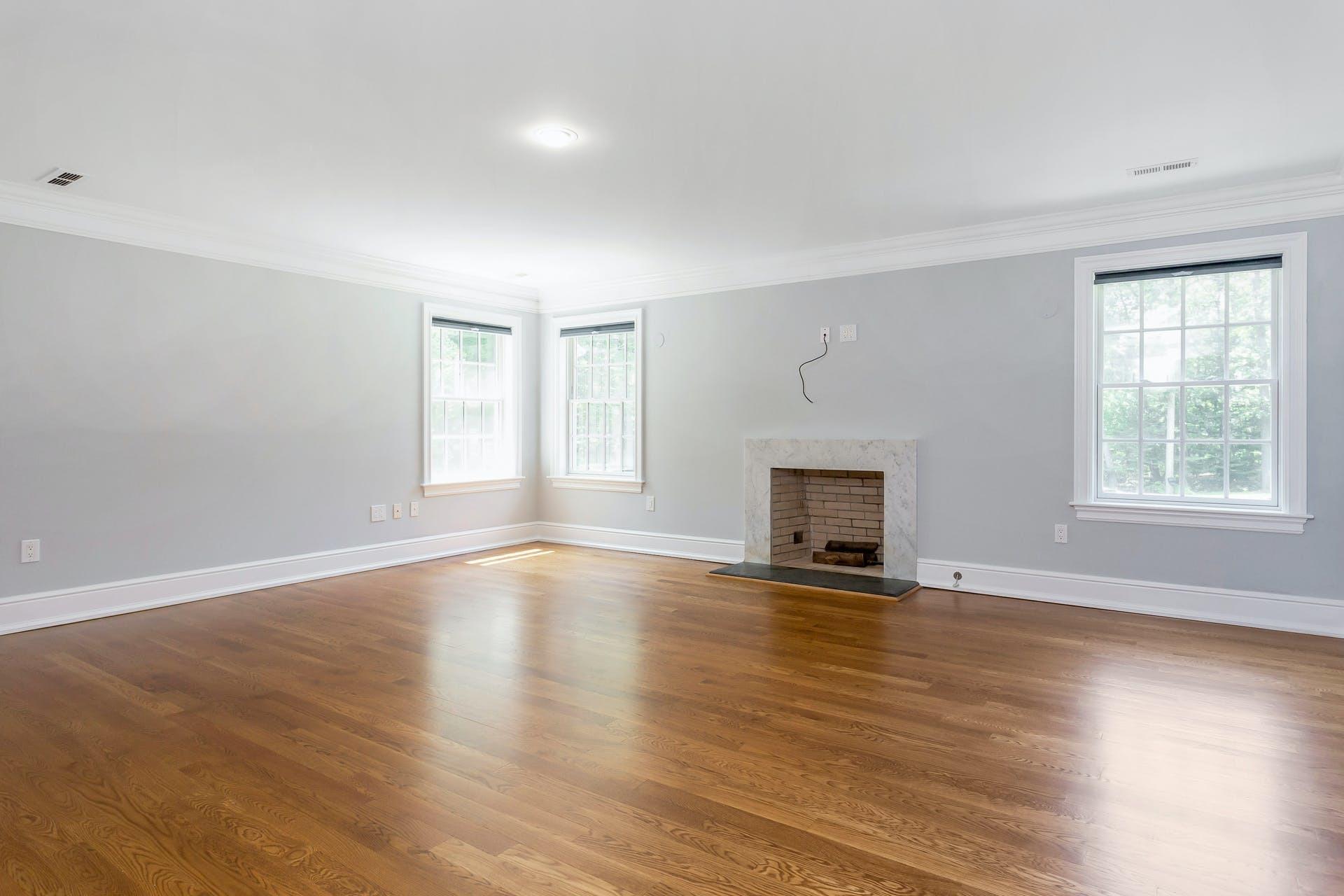 274 Mariomi Road New Canaan, CT 06840 - Photo 26 of 56 an empty room with wooden floor fireplace and windows