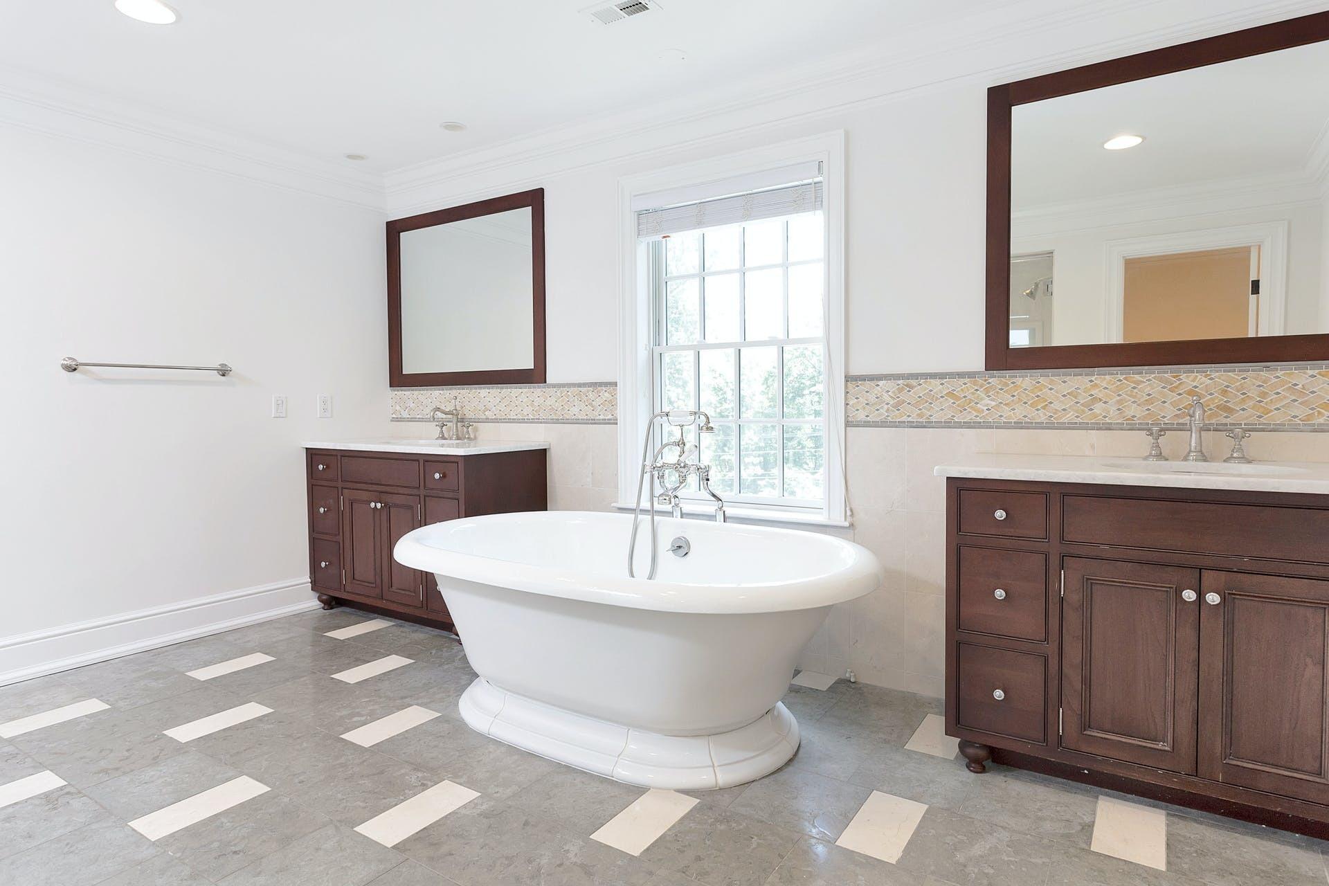274 Mariomi Road New Canaan, CT 06840 - Photo 30 of 56 a spacious bathroom with a double vanity sink a mirror and a bathtub