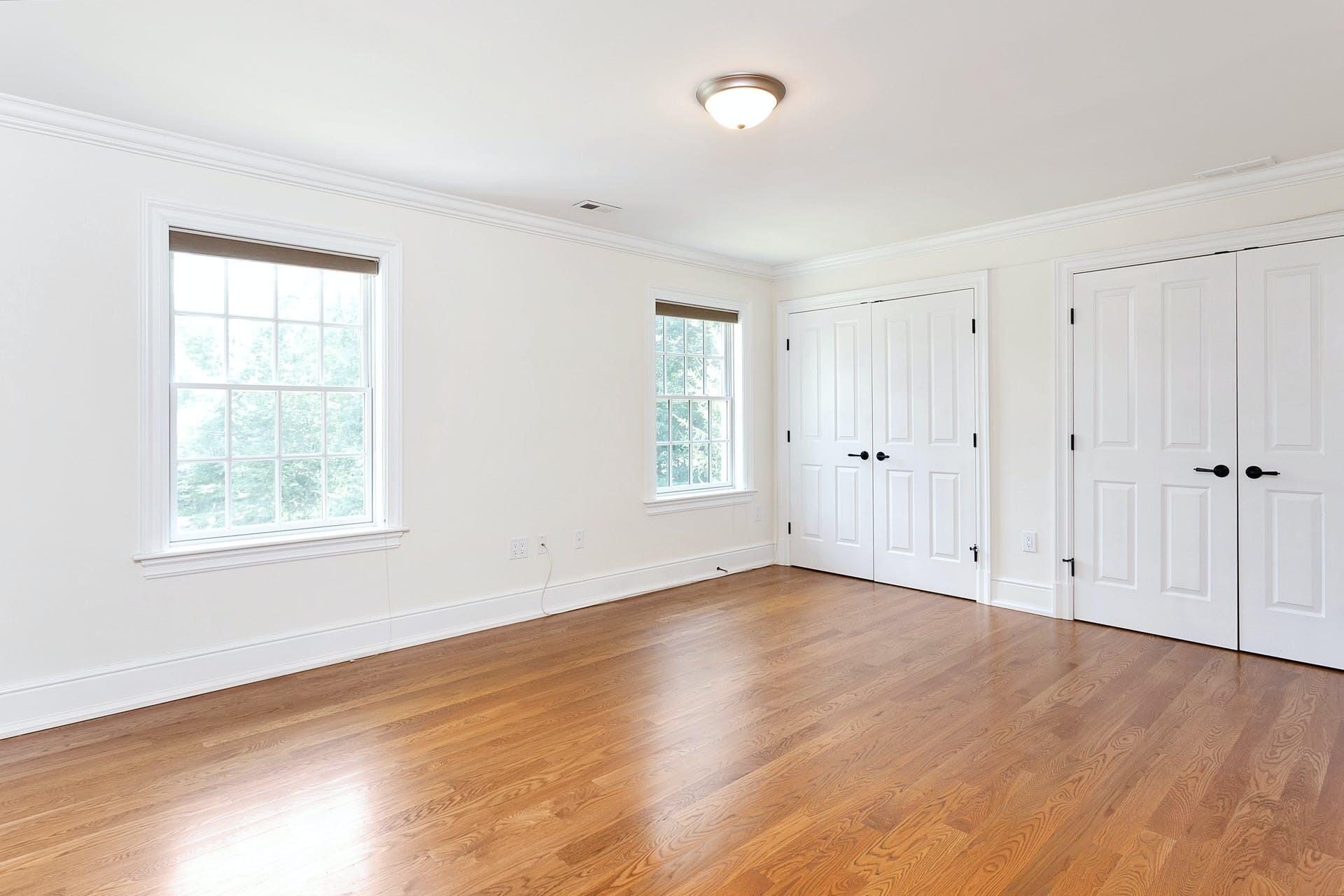 274 Mariomi Road New Canaan, CT 06840 - Photo 35 of 56 an empty room with wooden floor and windows