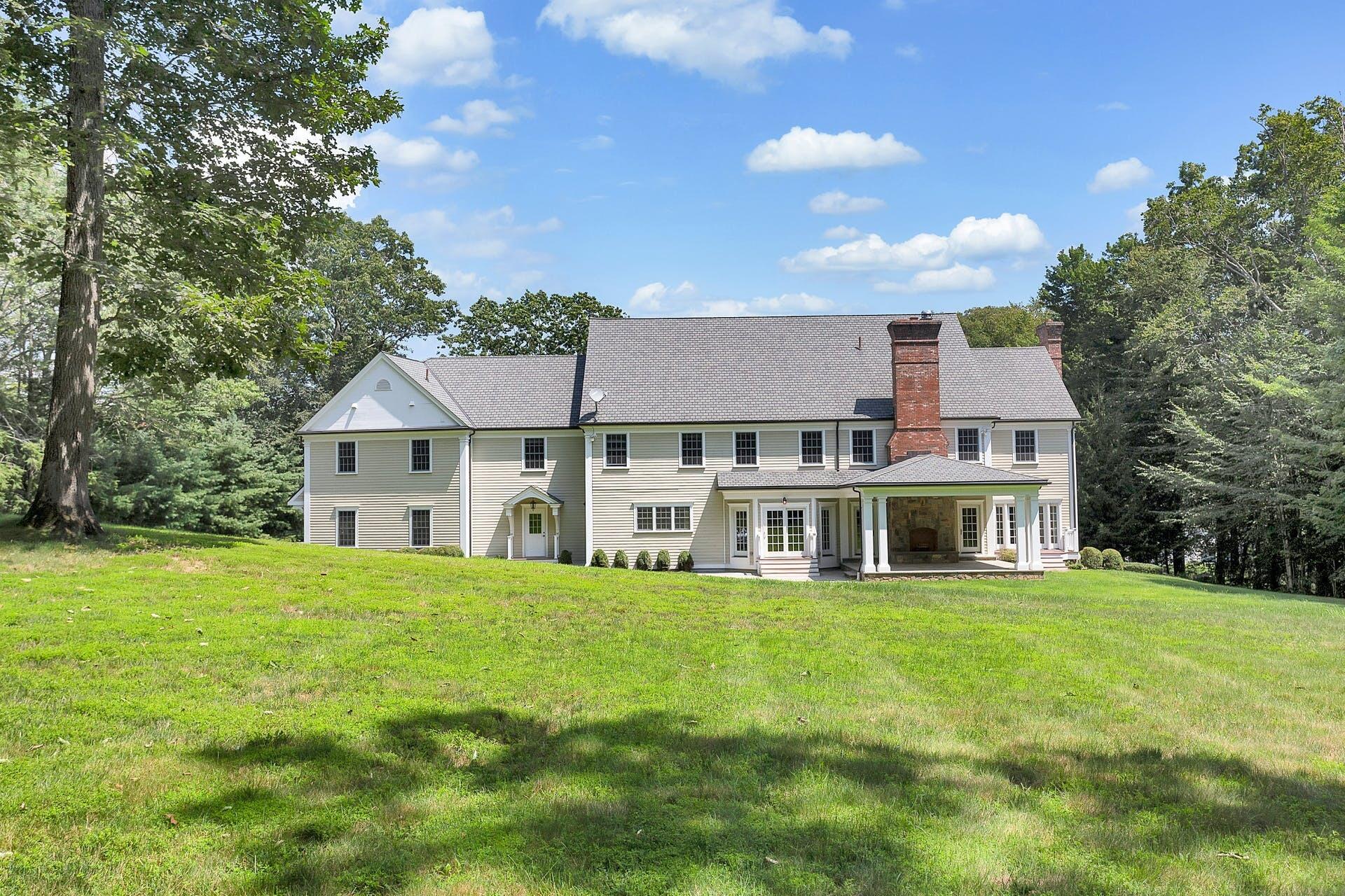 274 Mariomi Road New Canaan, CT 06840 - Photo 50 of 56 a view of a house with a big yard