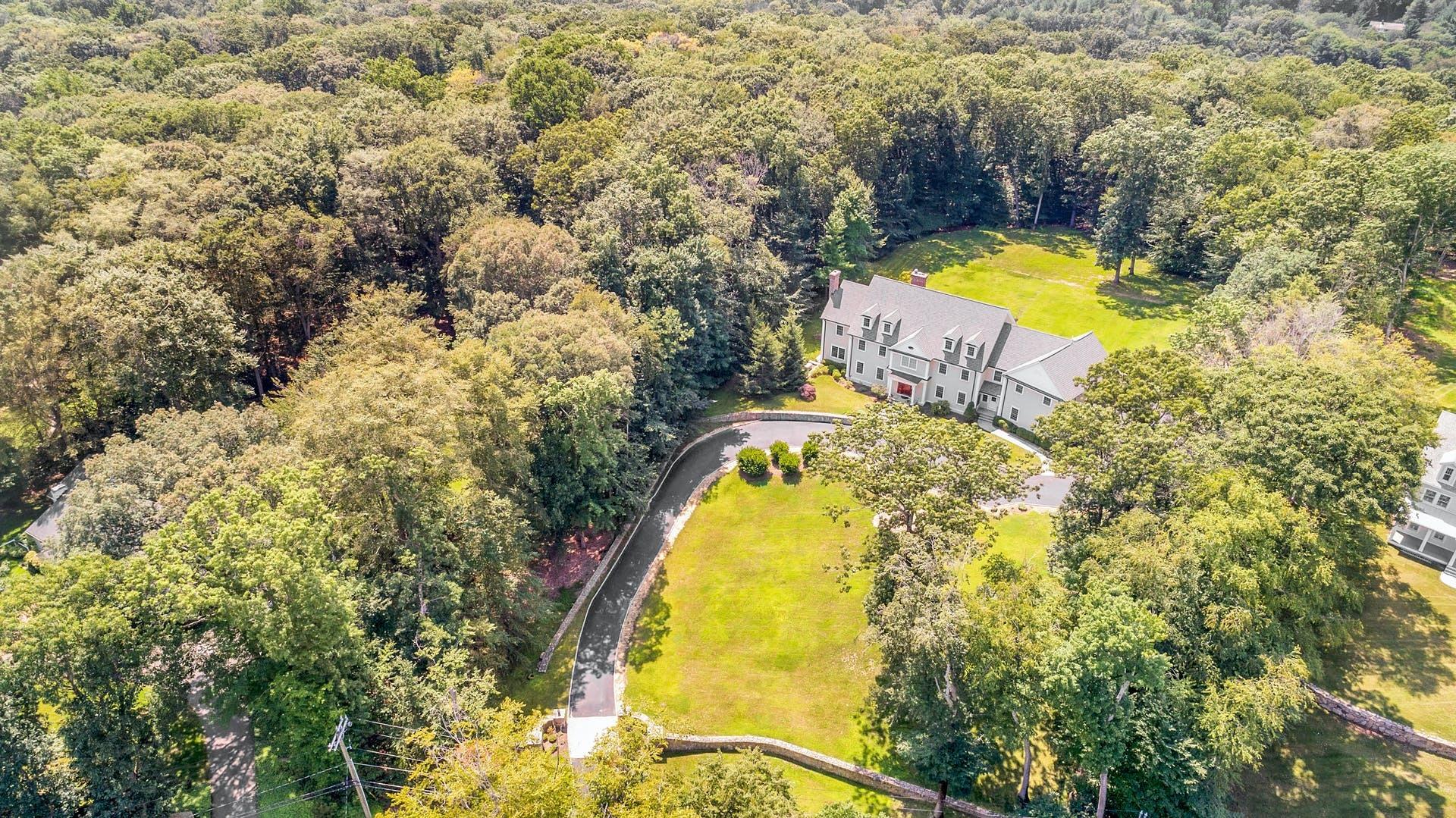 274 Mariomi Road New Canaan, CT 06840 - Photo 52 of 56 a view of a swimming pool in he middle of the house