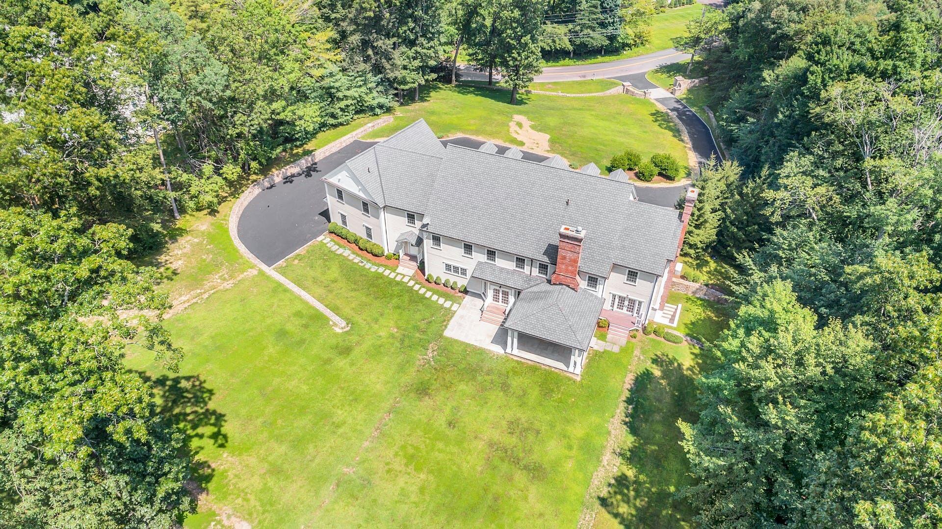 274 Mariomi Road New Canaan, CT 06840 - Photo 55 of 56 an aerial view of a house with a swimming pool