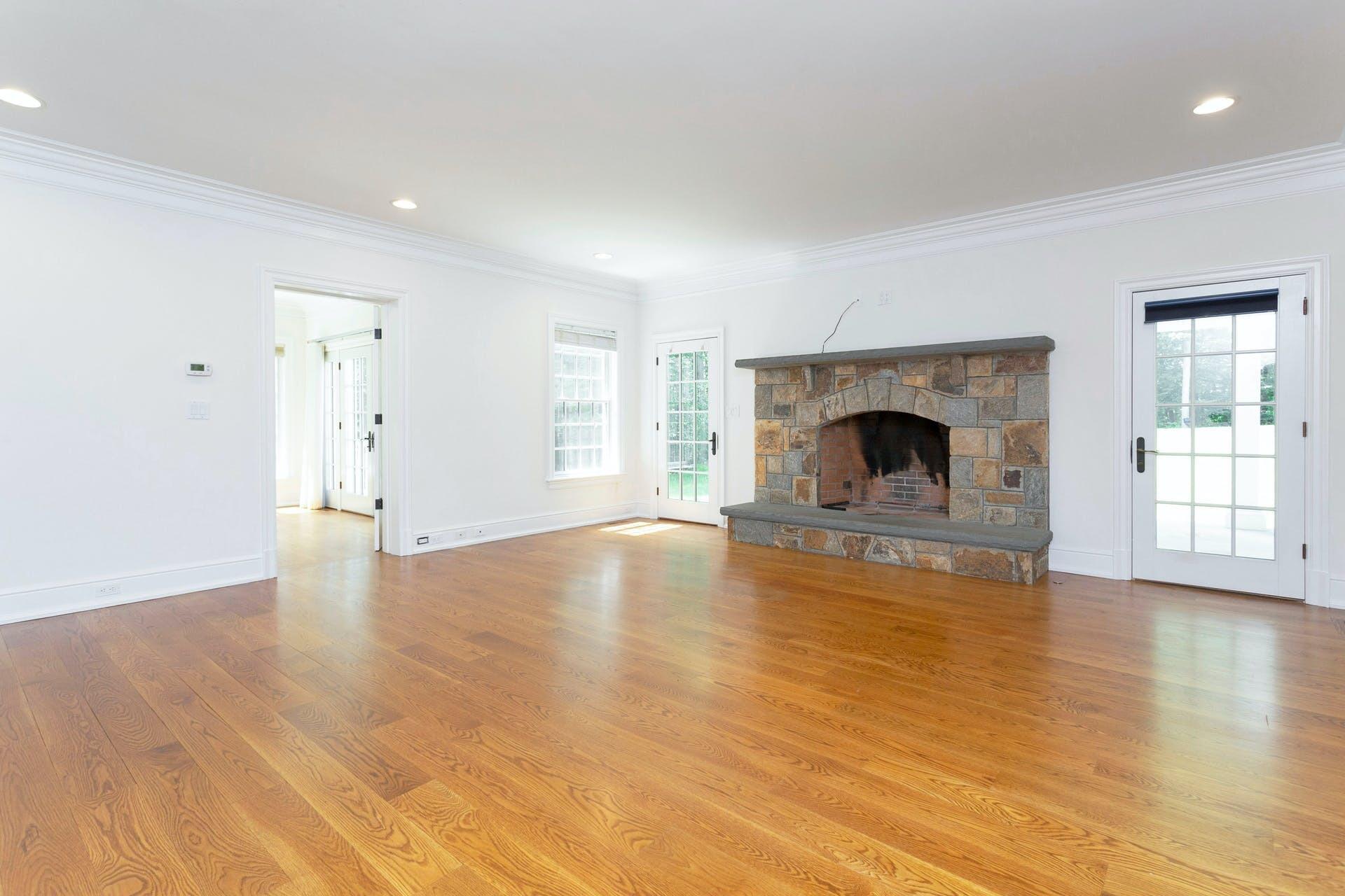 274 Mariomi Road New Canaan, CT 06840 - Photo 9 of 56 an empty room with wooden floor fireplace and windows