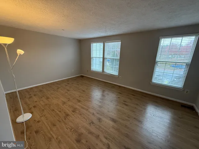 a view of room with window and hardwood floor