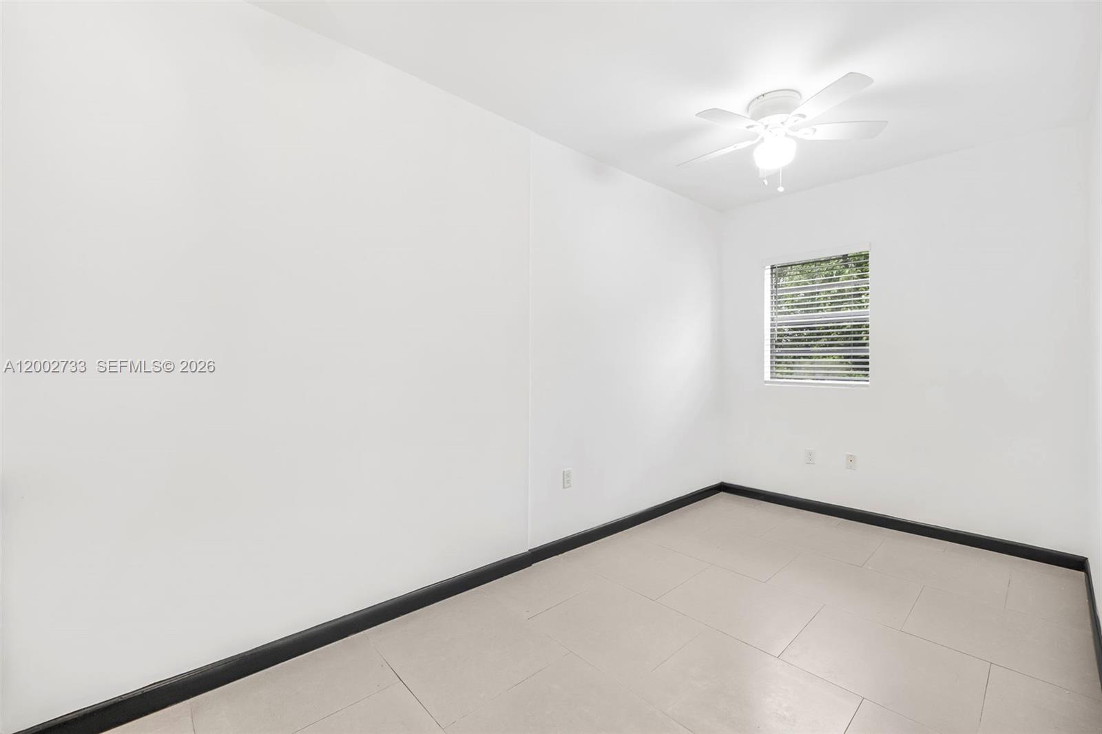 1876 Southwest 11th Terrace, Unit 302 Miami, FL 33135 - Photo 12 of 15 an empty room with a window