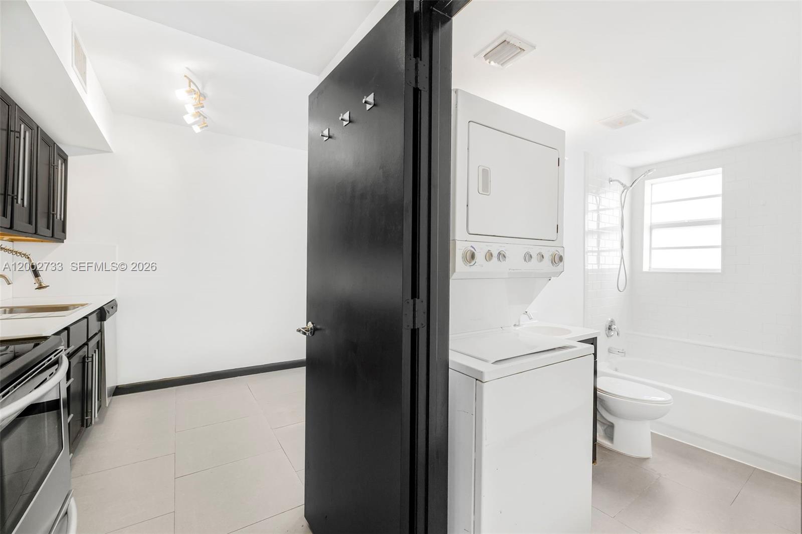 1876 Southwest 11th Terrace, Unit 302 Miami, FL 33135 - Photo 3 of 15 a white refrigerator freezer sitting inside of a kitchen