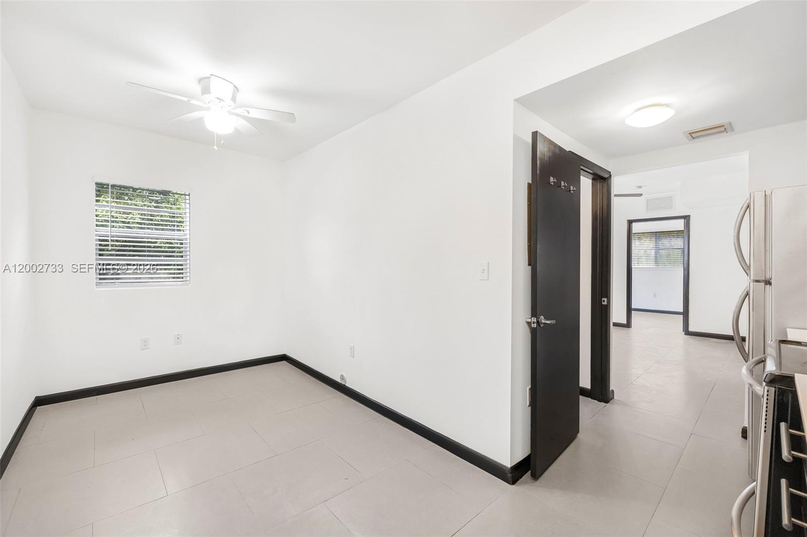 1876 Southwest 11th Terrace, Unit 302 Miami, FL 33135 - Photo 5 of 15 a view of a room with a ceiling fan