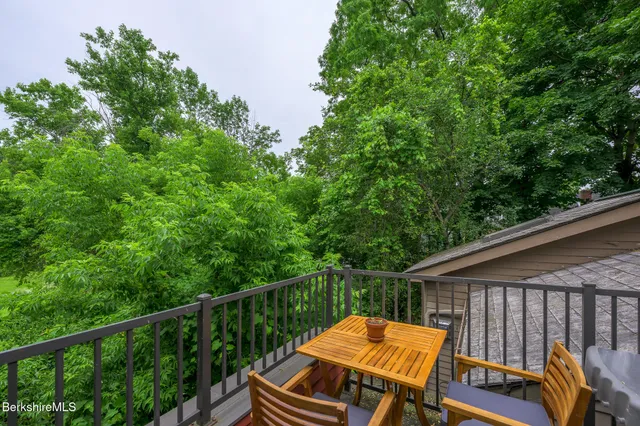 a view of a wooden deck and a backyard