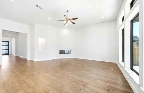 wooden floor in an empty room with a window