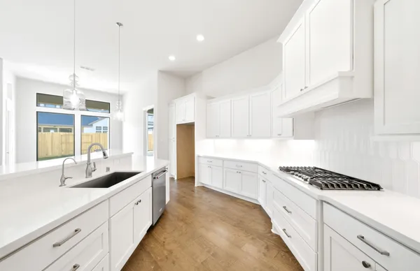a kitchen with granite countertop a sink and cabinets