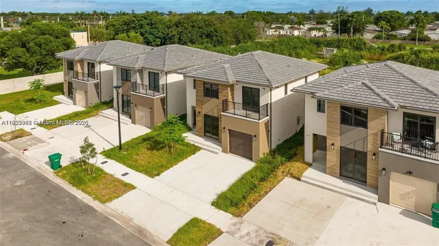 a aerial view of a house with a yard
