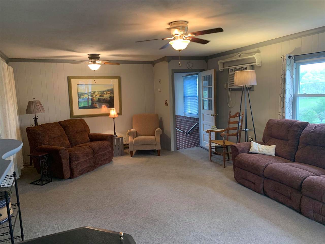 1504 Old Providence Road Raphine, VA 24472 - Photo 14 of 37 a living room with furniture a chandelier and a window