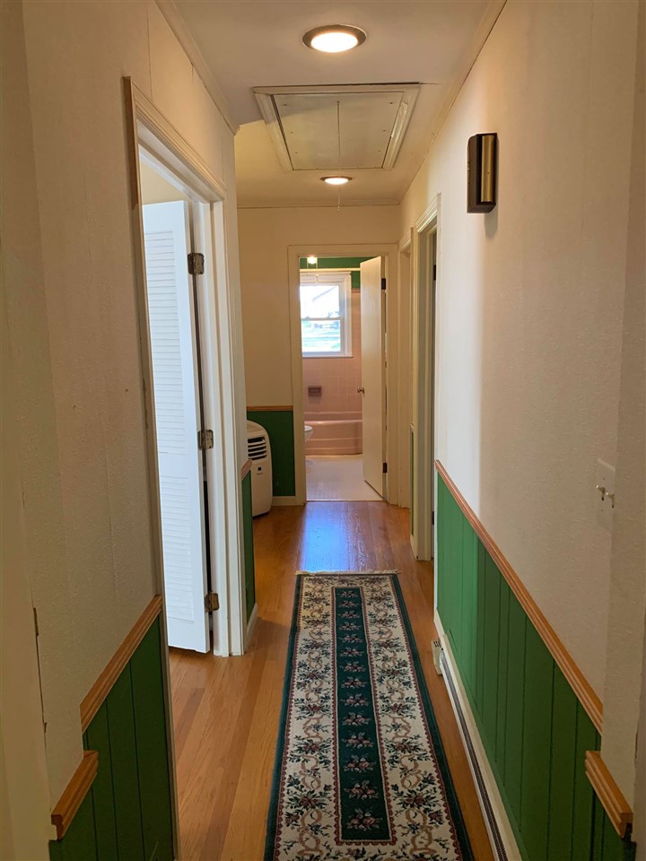 1504 Old Providence Road Raphine, VA 24472 - Photo 19 of 37 a hallway with white cabinets and black rug