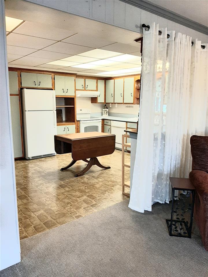 1504 Old Providence Road Raphine, VA 24472 - Photo 31 of 37 a living room with furniture and a refrigerator