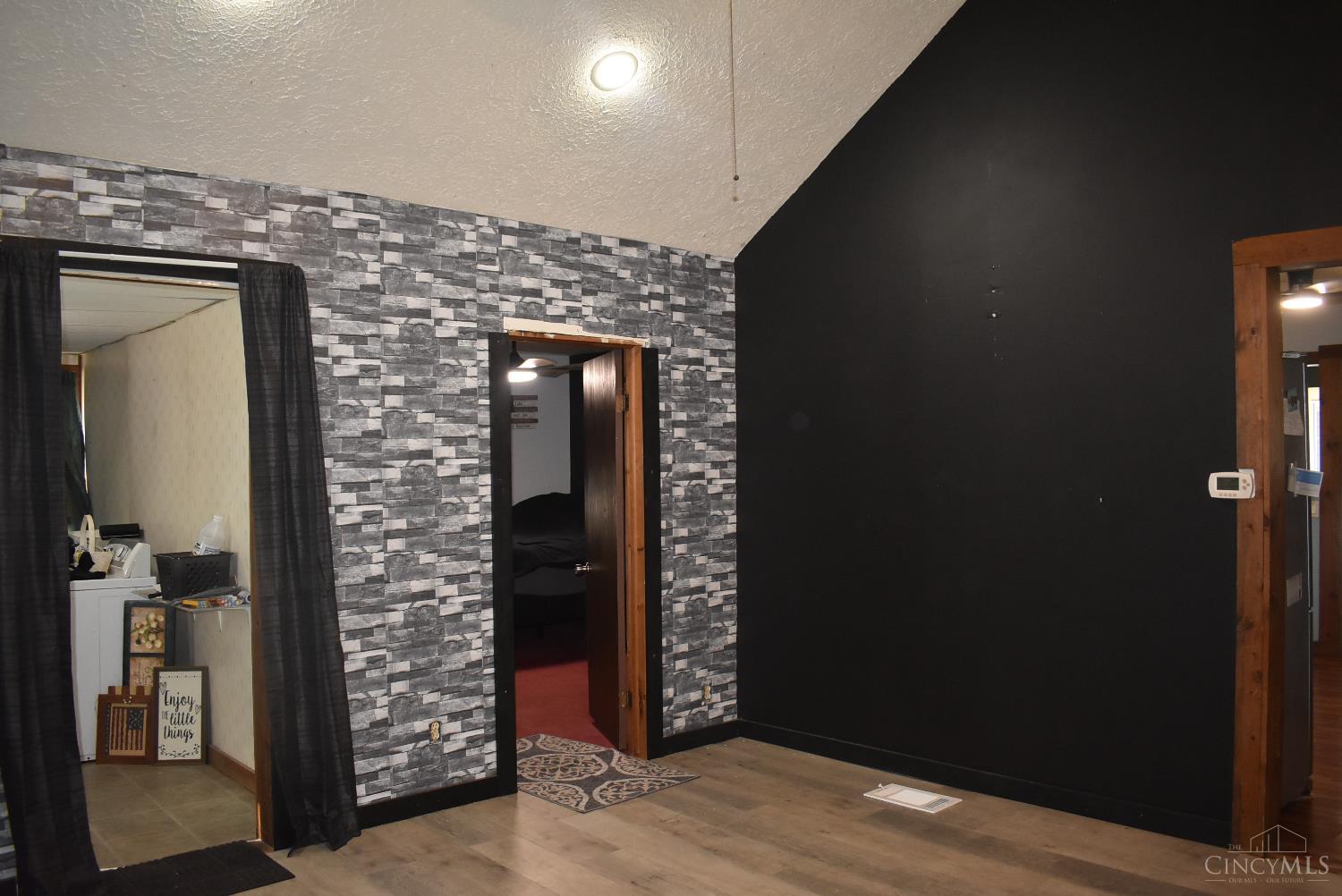 374 Exline Road Wellston, OH 45692 - Photo 20 of 33 Family room looking into bedroom and utility room kitchen to right