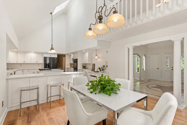 a kitchen with a dining table and chairs