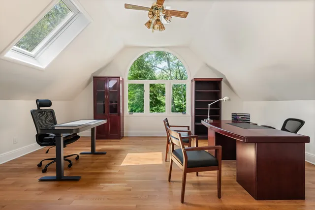 a bedroom with a bed and a dresser next to a window