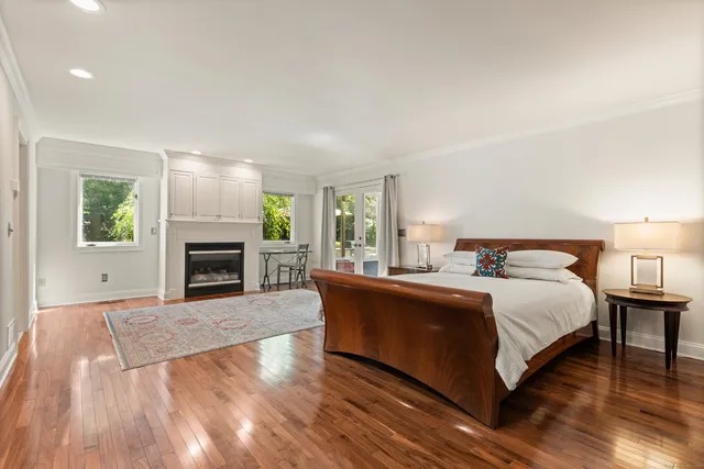 a spacious bathroom with a tub sink and mirror