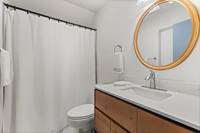 a spacious bedroom with a bed and a large window