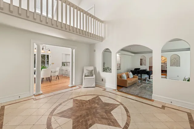 a bedroom with furniture and large mirror