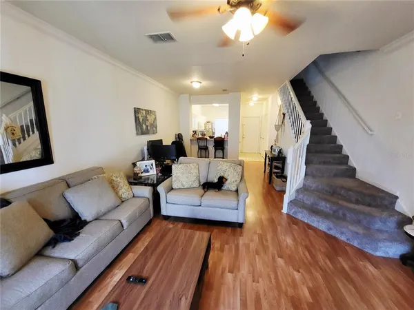 a view of a livingroom with furniture and a window