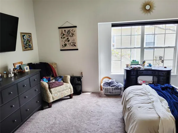 a bedroom with a bed and a couch