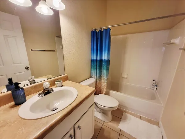 a bedroom with a bed and a mirror