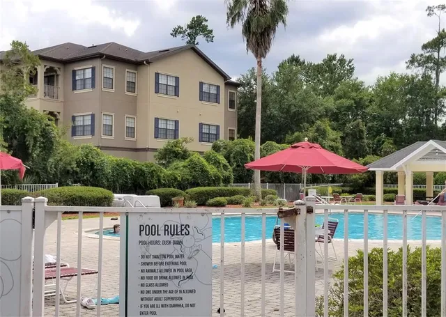 a view of a patio with a table and chairs under an umbrella