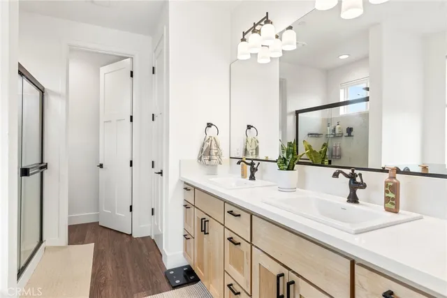 a bathroom with a double vanity sink and a mirror