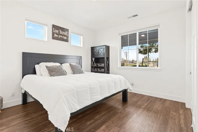 a bedroom with a bed and a large mirror