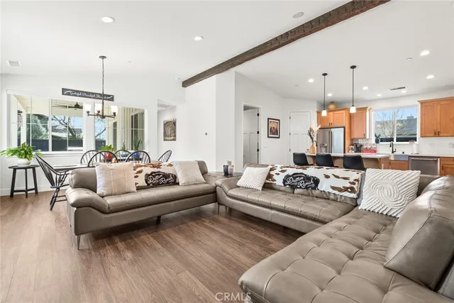 a living room with furniture kitchen and a chandelier