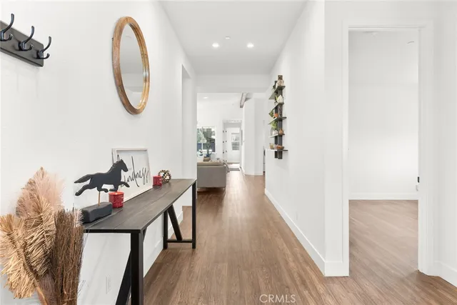 a very nice looking room with wooden floor and furniture