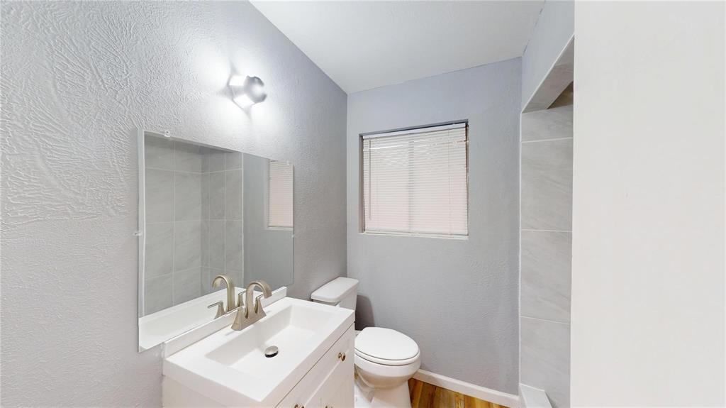 5817 Sandra Drive Fort Worth, TX 76133 - Photo 11 of 26 a bathroom with a toilet a sink and mirror