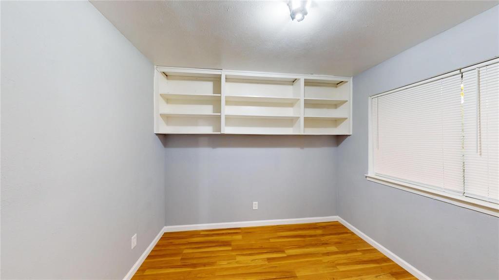 5817 Sandra Drive Fort Worth, TX 76133 - Photo 16 of 26 a room with a wooden floor and a window