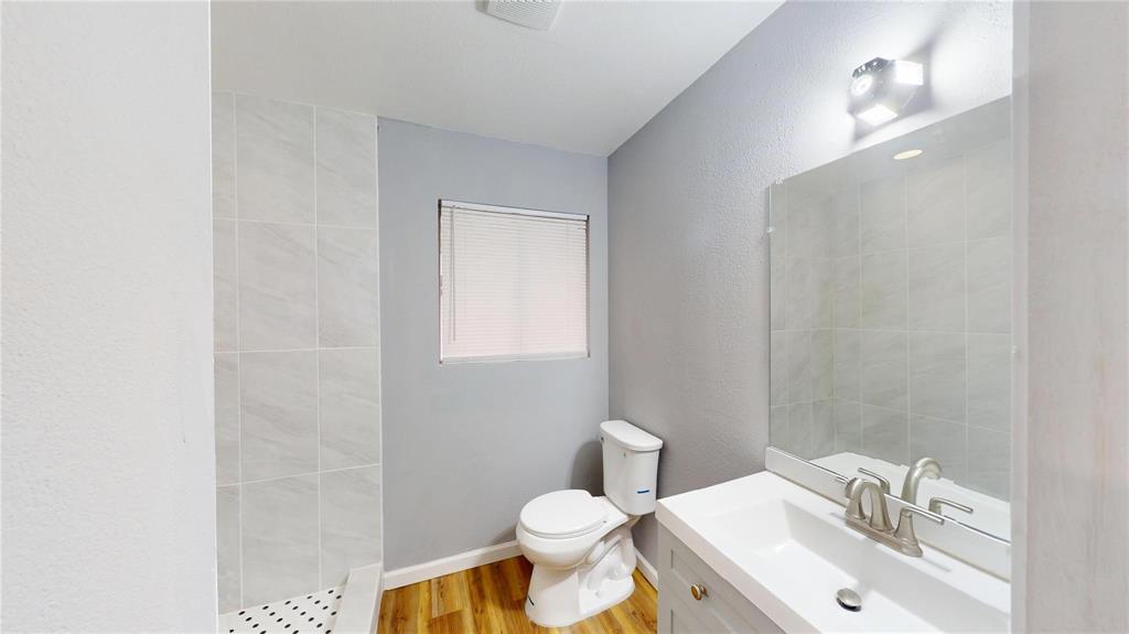 5817 Sandra Drive Fort Worth, TX 76133 - Photo 17 of 26 a bathroom with a sink toilet and a mirror