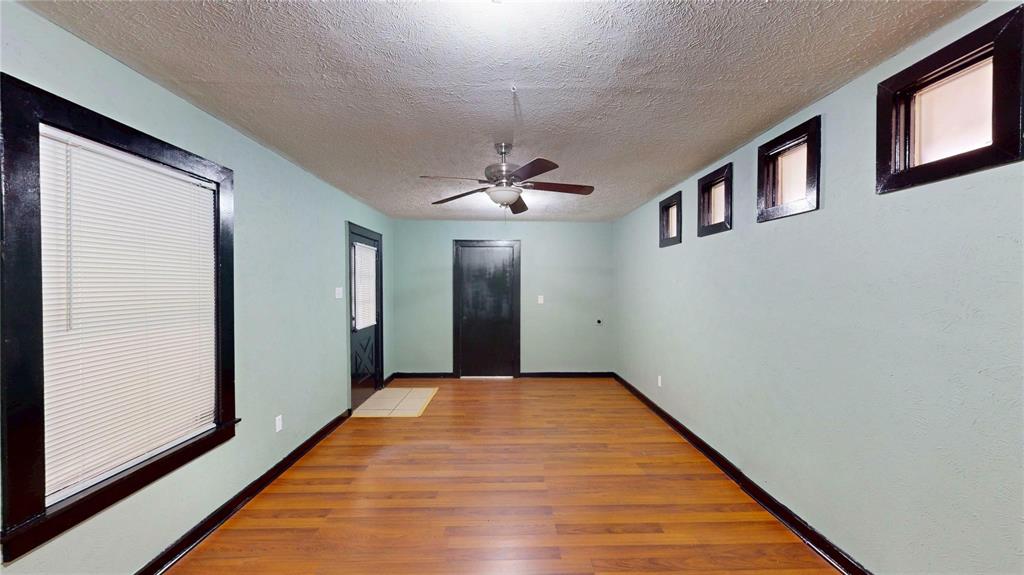 5817 Sandra Drive Fort Worth, TX 76133 - Photo 20 of 26 a view of a hallway with wooden floor and a chandelier