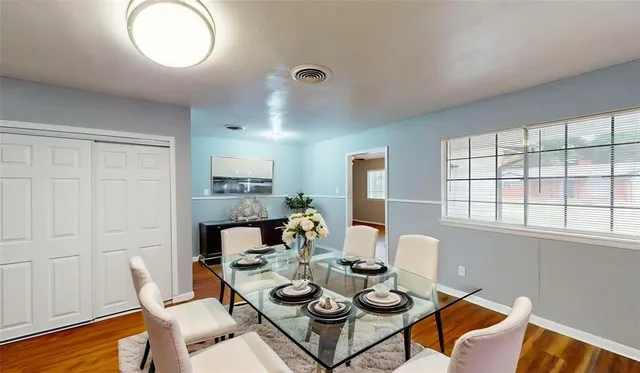 a view of a dining room with furniture and wooden floor