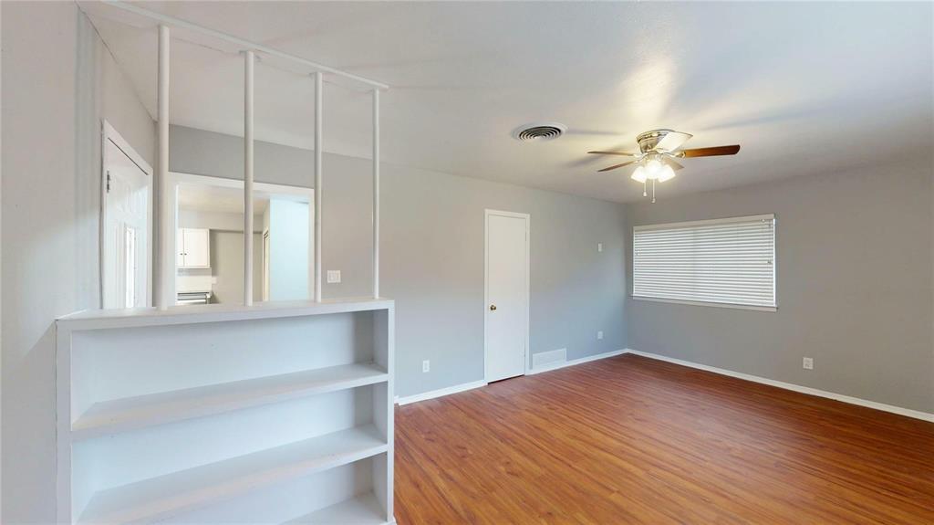 5817 Sandra Drive Fort Worth, TX 76133 - Photo 8 of 26 a bedroom with a bed and a chandelier